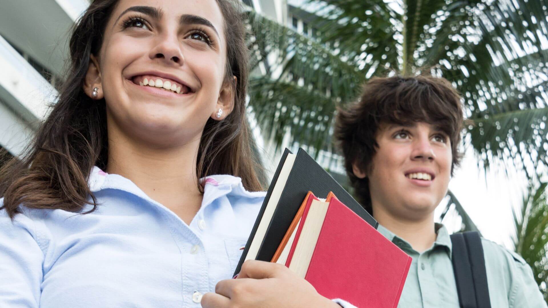 two high school students with books