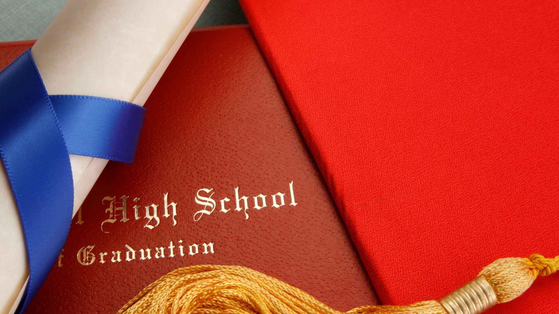 high school graduate documents with ribbon next to graduate folder